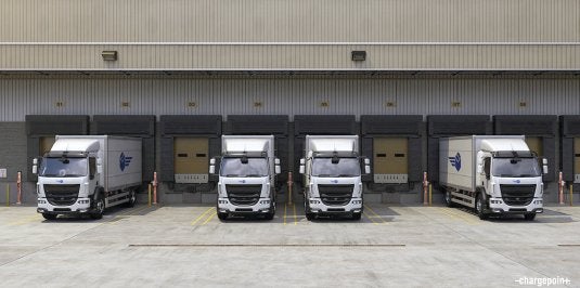 Electric delivery fleet vehicles in depot